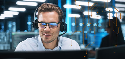 Man with headset on, working at computer monitor 